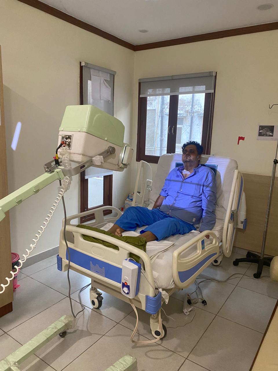 Portable X-ray being set up at a patient's bedside in their home